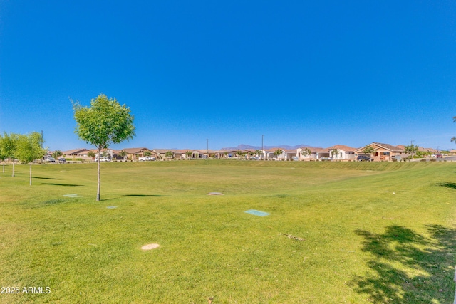 view of property's community featuring a residential view and a lawn