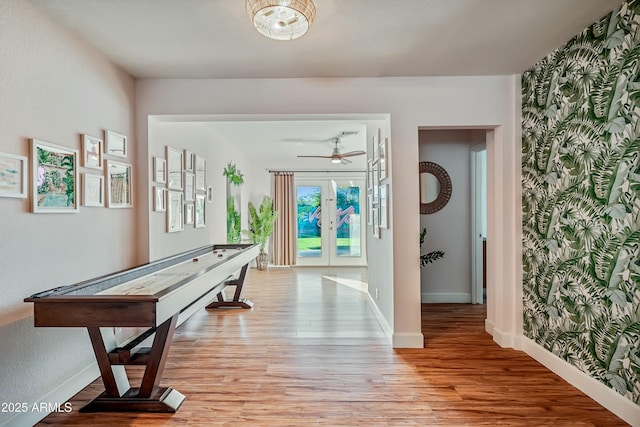 playroom featuring ceiling fan, light wood-type flooring, and french doors