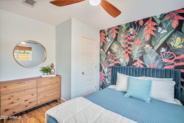 bedroom with hardwood / wood-style floors and ceiling fan