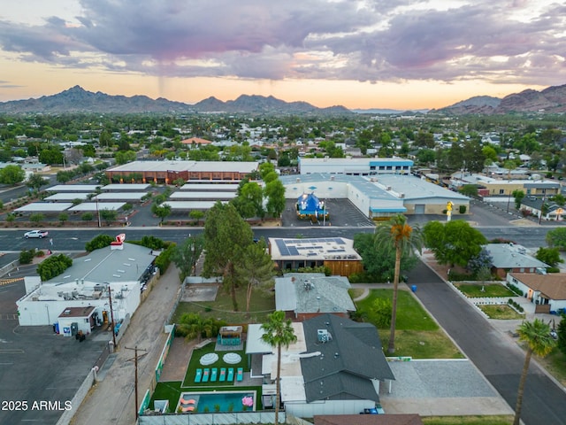 aerial view at dusk featuring a mountain view