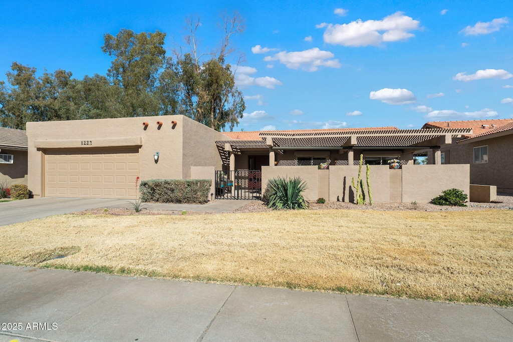 pueblo revival-style home with a garage