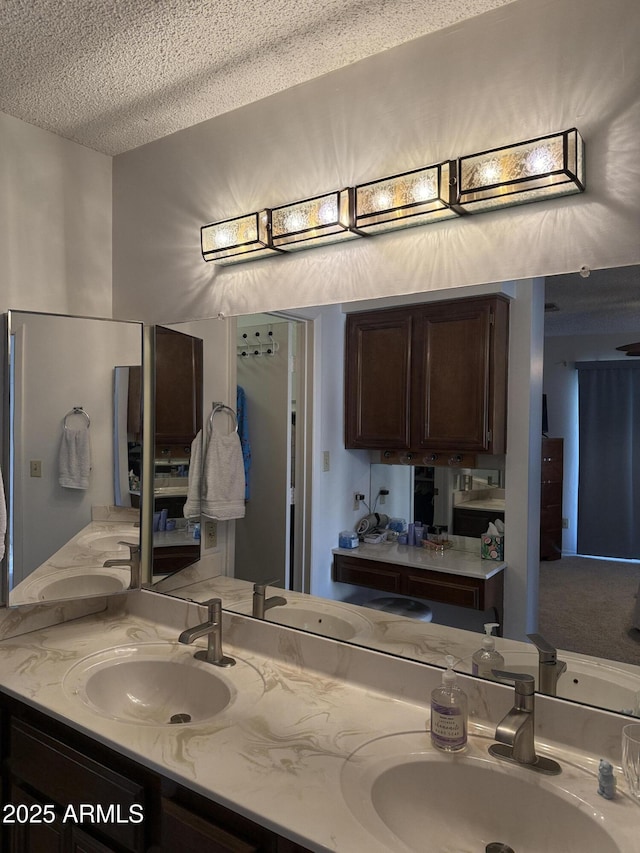 bathroom featuring sink and a textured ceiling