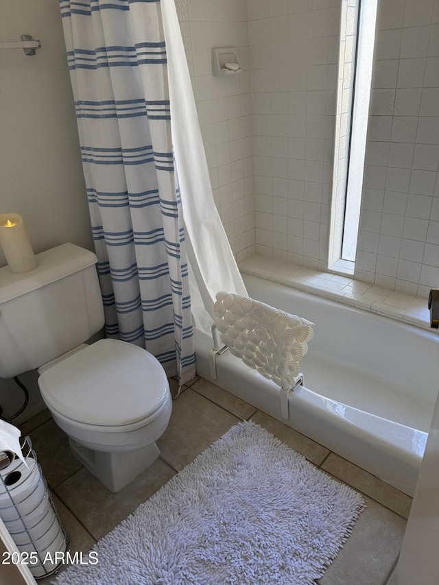 bathroom with tile patterned floors, toilet, and shower / tub combo