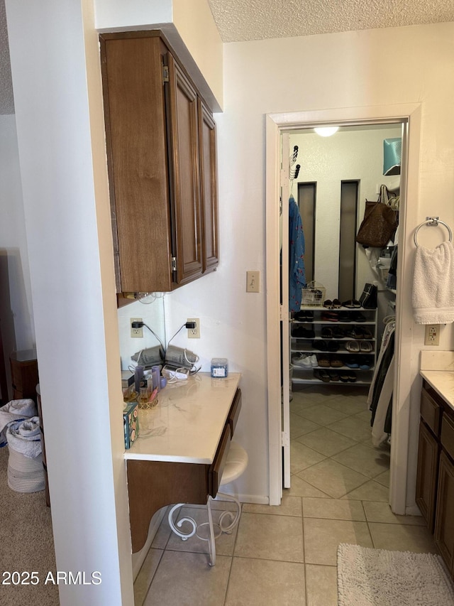 bathroom with tile patterned floors and a textured ceiling