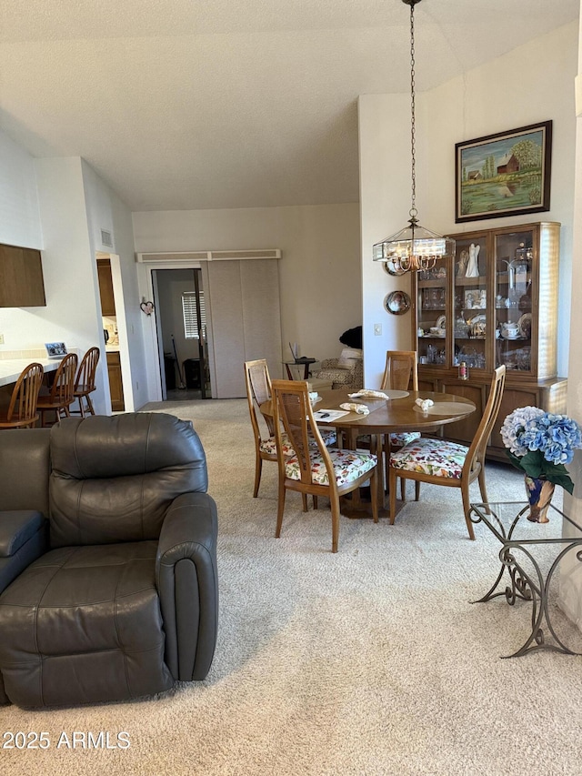 dining room featuring carpet floors and a notable chandelier