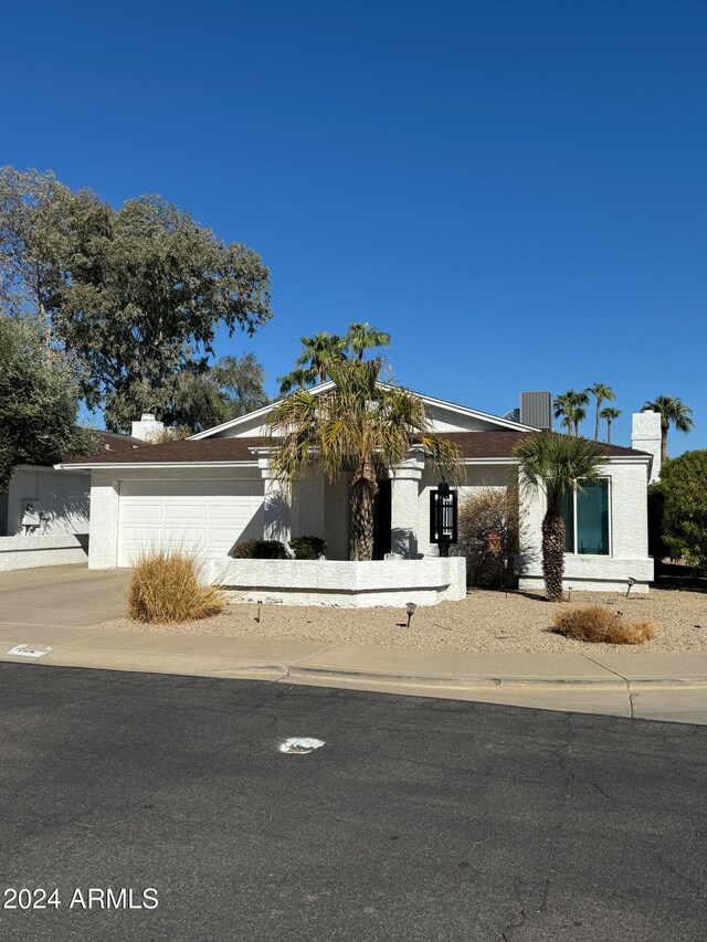 view of front facade with a garage and central air condition unit