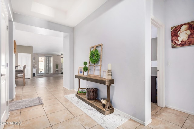 hall featuring light tile patterned flooring