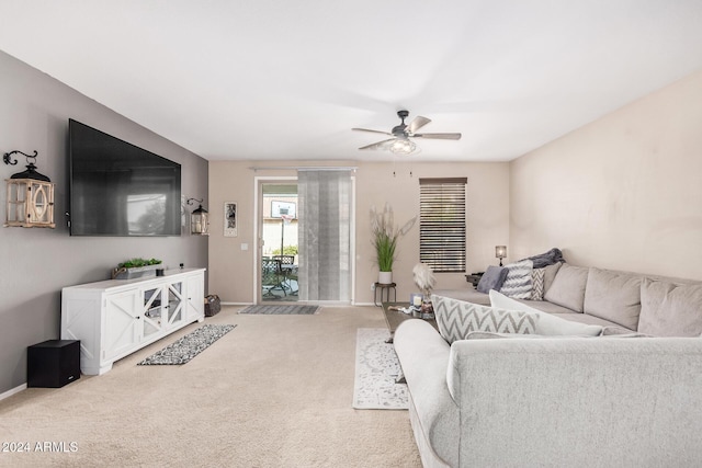 carpeted living room with ceiling fan