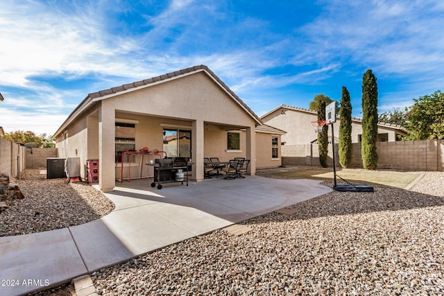 back of property with a patio and central AC unit