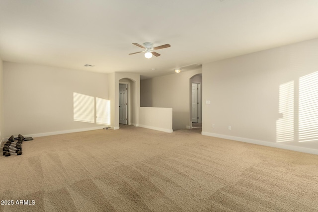 carpeted spare room featuring ceiling fan