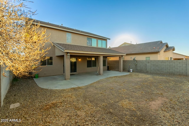 back of property with a patio