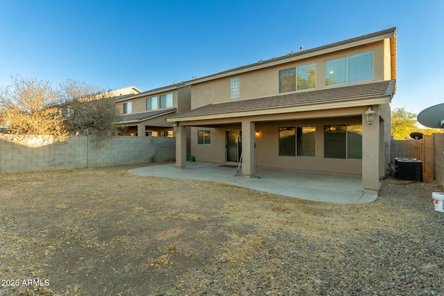 rear view of property with central AC unit and a patio area