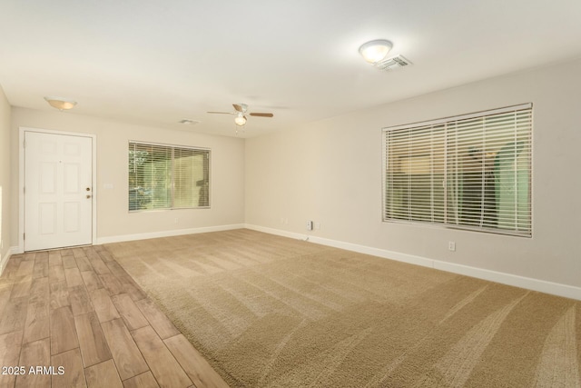 empty room with ceiling fan and hardwood / wood-style floors