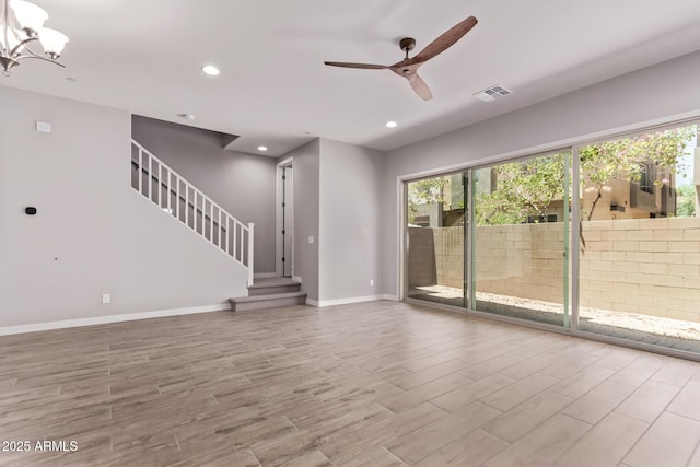 7492 E Via De Luna Dr, Scottsdale, AZ 85255 - unfurnished living room featuring healthy amount of natural light, ceiling fan, wood finished floors, recessed lighting, and stairway