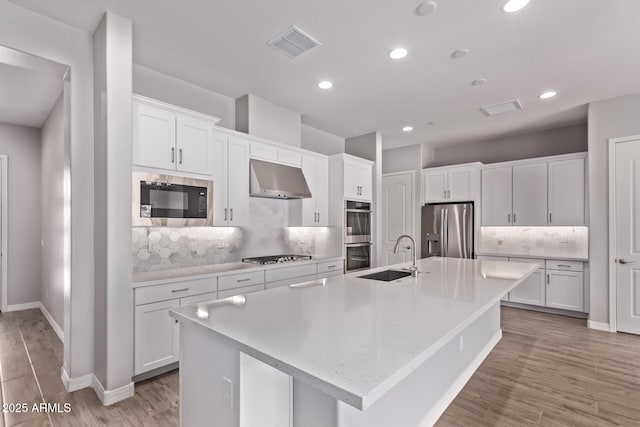 7492 E Via De Luna Dr, Scottsdale, AZ 85255 - kitchen featuring stainless steel appliances, exhaust hood, white cabinetry, tasteful backsplash, and recessed lighting