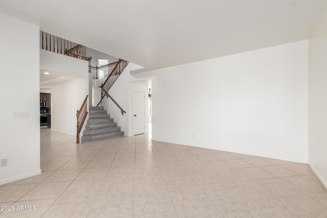 2302 S Canfield, Mesa, AZ 85209 - spare room with stairway, light tile patterned flooring, and a high ceiling