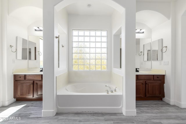 2302 S Canfield, Mesa, AZ 85209 - bathroom featuring a garden tub, wood finished floors, two vanities, and baseboards