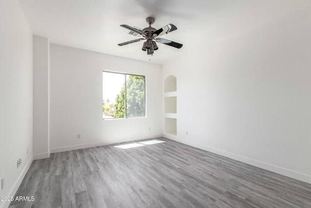 2302 S Canfield, Mesa, AZ 85209 - unfurnished room with wood finished floors, ceiling fan, and baseboards