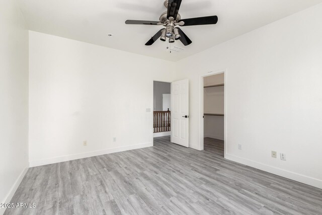 2302 S Canfield, Mesa, AZ 85209 - unfurnished bedroom featuring wood finished floors, baseboards, and a walk in closet