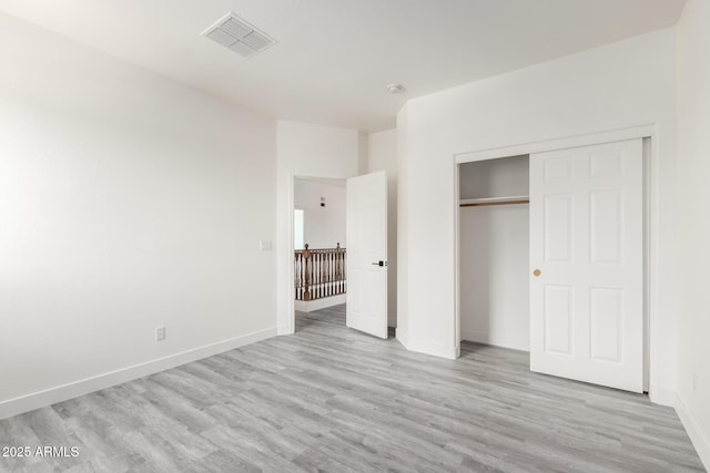 2302 S Canfield, Mesa, AZ 85209 - unfurnished bedroom featuring light wood-type flooring, baseboards, and a closet