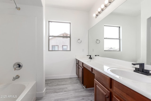 2302 S Canfield, Mesa, AZ 85209 - bathroom with double vanity, shower / washtub combination, wood finished floors, and baseboards