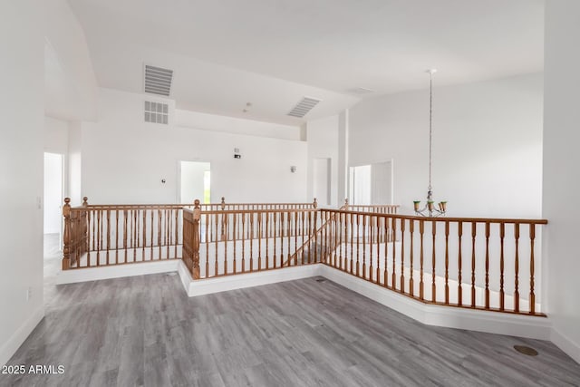 2302 S Canfield, Mesa, AZ 85209 - empty room featuring a chandelier, high vaulted ceiling, wood finished floors, and baseboards