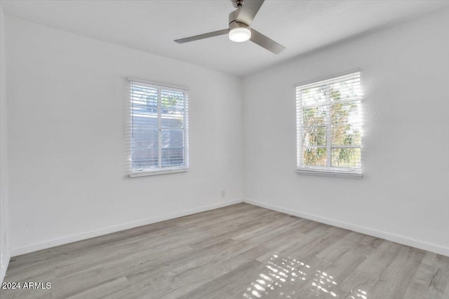 empty room with light wood-type flooring and ceiling fan