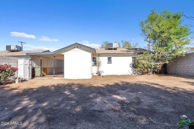 back of house featuring central AC unit