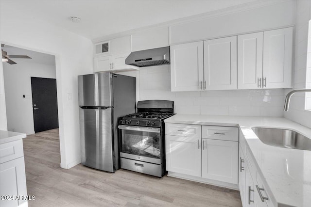 kitchen featuring white cabinets, sink, stainless steel appliances, and exhaust hood