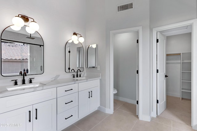3624 N Paseo Del Sol, Mesa, AZ 85207 - full bath featuring double vanity, a spacious closet, tile patterned flooring, and toilet