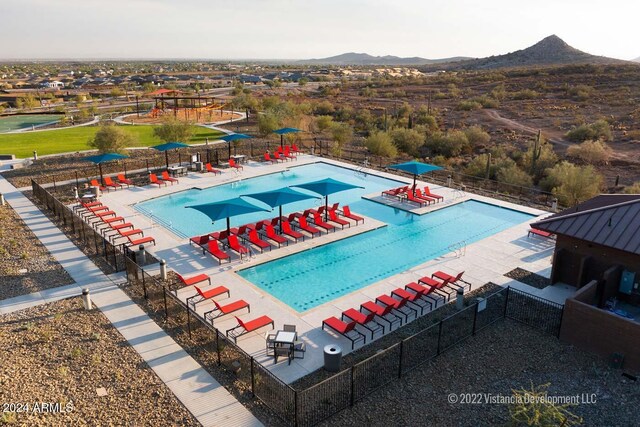 view of swimming pool with a patio, central air condition unit, and a mountain view