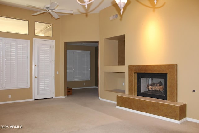 34464 N 68th Way, Scottsdale, AZ 85266 - unfurnished living room with carpet flooring, ceiling fan, a fireplace, and a high ceiling