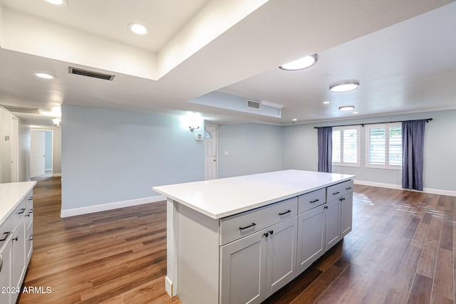 kitchen featuring white cabinetry, dark hardwood / wood-style flooring, and a kitchen island