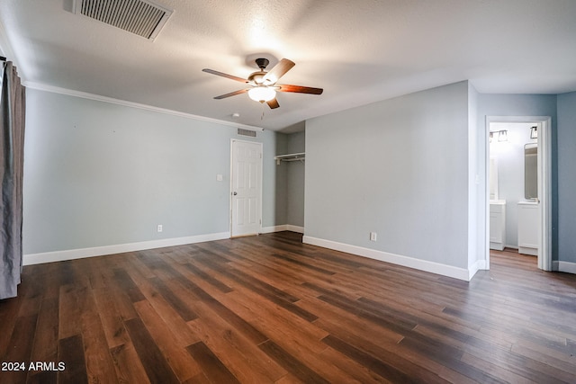 unfurnished bedroom featuring dark wood-type flooring, crown molding, ceiling fan, a textured ceiling, and a closet