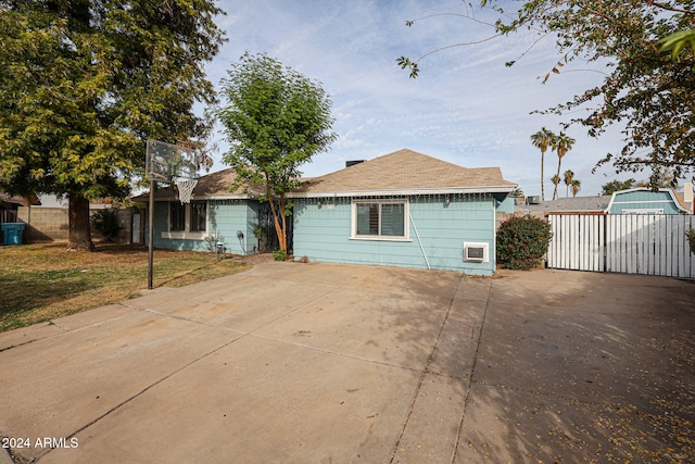 rear view of property featuring a yard