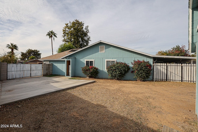 back of property with a carport