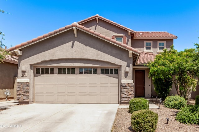 932 W Capulin Trl, San Tan Valley, AZ 85140 - mediterranean / spanish-style home featuring stone siding, a garage, a tile roof, and concrete driveway