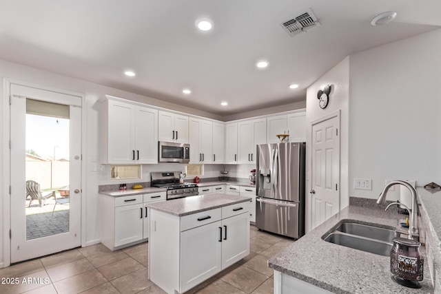 932 W Capulin Trl, San Tan Valley, AZ 85140 - kitchen featuring stainless steel appliances, a sink, light stone countertops, white cabinetry, and recessed lighting