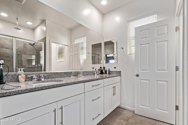 932 W Capulin Trl, San Tan Valley, AZ 85140 - bathroom featuring double vanity, a stall shower, baseboards, and tile patterned flooring
