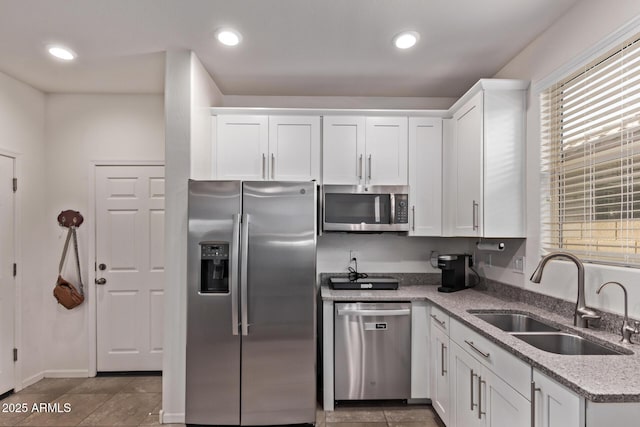932 W Capulin Trl, San Tan Valley, AZ 85140 - kitchen featuring stainless steel appliances, a sink, white cabinets, light stone counters, and recessed lighting