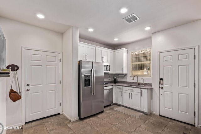 932 W Capulin Trl, San Tan Valley, AZ 85140 - kitchen featuring appliances with stainless steel finishes, a sink, white cabinetry, dark countertops, and baseboards