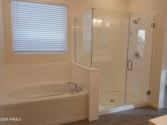 bathroom featuring wood-type flooring and independent shower and bath