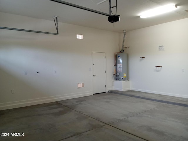 garage with water heater and a garage door opener