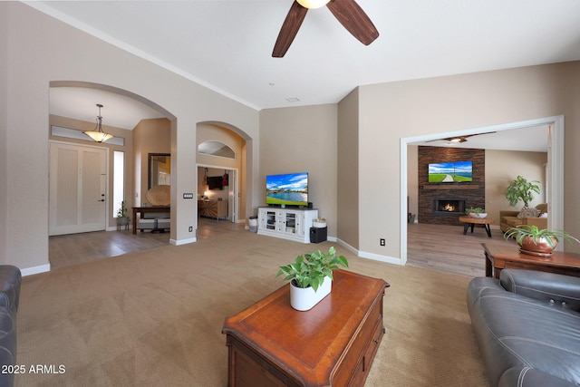 26647 N 43rd St N, Cave Creek, AZ 85331 - living area featuring light colored carpet, arched walkways, a ceiling fan, and a fireplace