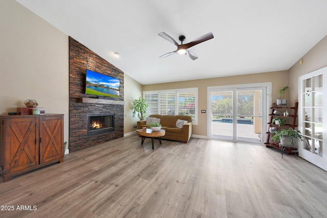 26647 N 43rd St N, Cave Creek, AZ 85331 - living room featuring ceiling fan, light wood-style floors, high vaulted ceiling, and a stone fireplace
