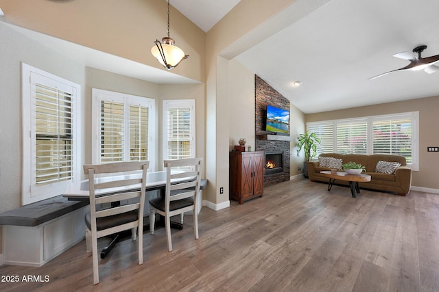26647 N 43rd St N, Cave Creek, AZ 85331 - dining space with wood finished floors, a fireplace, a ceiling fan, and high vaulted ceiling