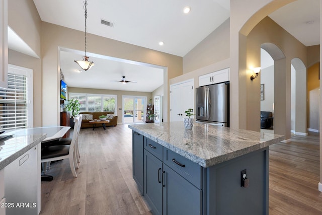 26647 N 43rd St N, Cave Creek, AZ 85331 - kitchen featuring stainless steel refrigerator with ice dispenser, arched walkways, light wood-type flooring, ceiling fan, and vaulted ceiling