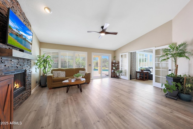 26647 N 43rd St N, Cave Creek, AZ 85331 - living area with a ceiling fan, a fireplace, vaulted ceiling, healthy amount of natural light, and light wood-style floors