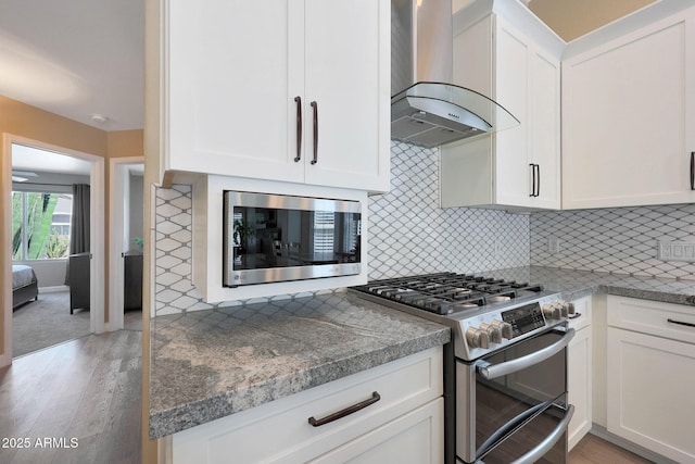 26647 N 43rd St N, Cave Creek, AZ 85331 - kitchen with stainless steel appliances, wall chimney exhaust hood, light wood-style floors, and white cabinets