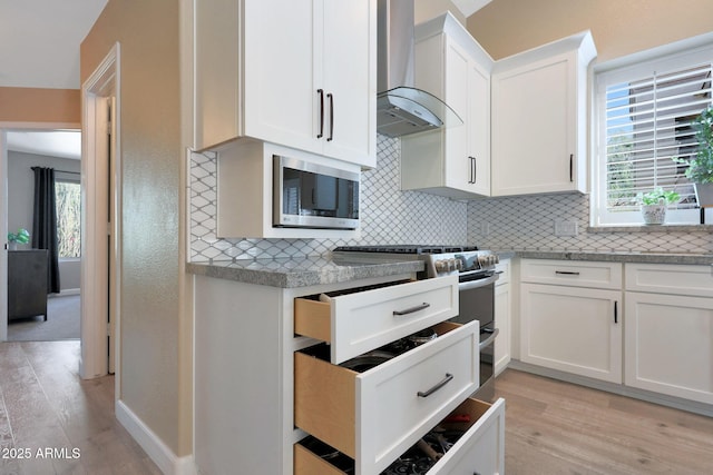 26647 N 43rd St N, Cave Creek, AZ 85331 - kitchen featuring wall chimney exhaust hood, stainless steel appliances, tasteful backsplash, and light wood-style flooring